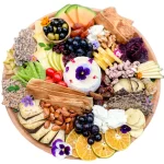 A Cheese Board With A Mix of Cheeses and Fruits
