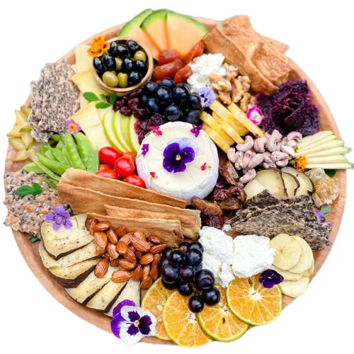 A Cheese Board With A Mix of Cheeses and Fruits